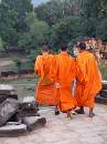  novice monks leaving after praying at the temple of phnom bakheng
