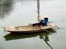  people in kenh ga row boats with their feet - and so having their hands free to work with